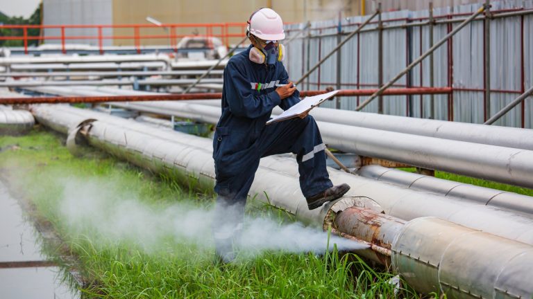 Oil and gas maintenance workers inspecting pressure gauges