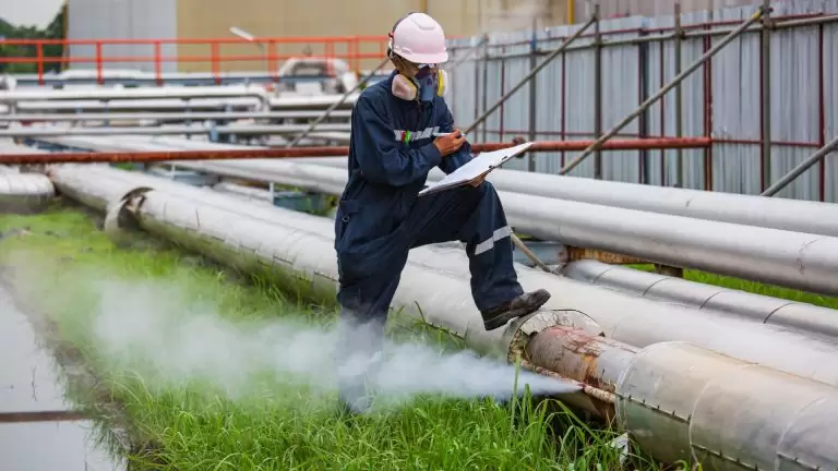 Oil and gas maintenance workers inspecting pressure gauges