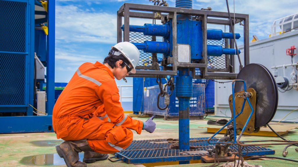 Oil and gas worker using tablet for field assessment